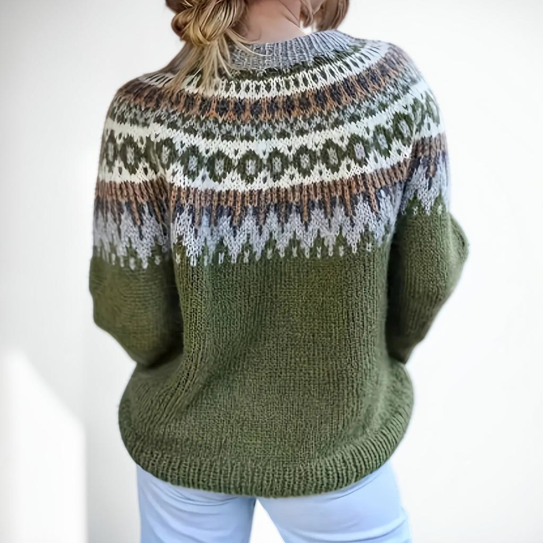 Vivian &amp; Cole Etta sweater featuring a green base with a festive Nordic jacquard pattern on the crew neck and yoke.