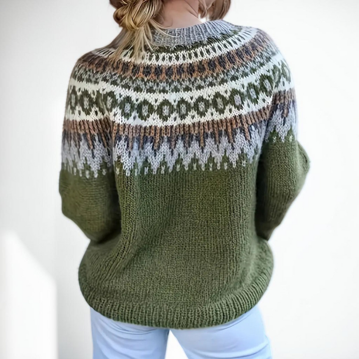 Vivian &amp; Cole Etta sweater featuring a green base with a festive Nordic jacquard pattern on the crew neck and yoke.