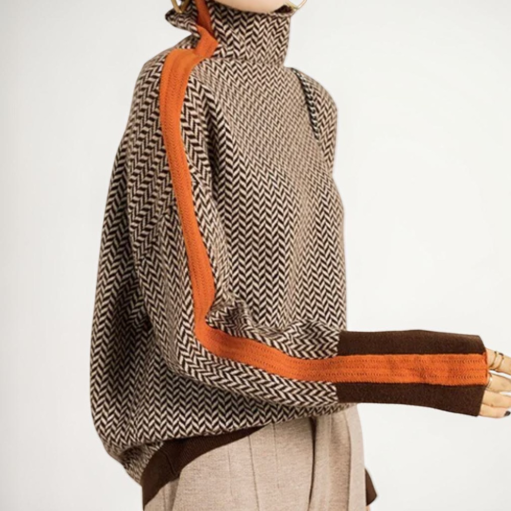 Vivian & Cole Sophia turtleneck sweater featuring a brown and black herringbone pattern with orange side stripes.