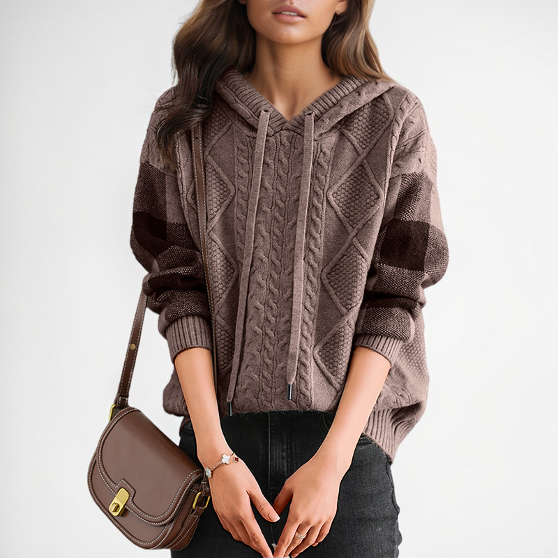 Vivian & Cole Luna brown cable-knit hooded sweater with ribbed cuffs and drawstring detail worn with black jeans.