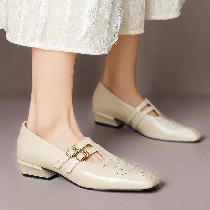 Vivian &amp; Cole Marisol beige leather Mary Jane pumps with brogue detailing, dual buckled straps, and a low block heel.