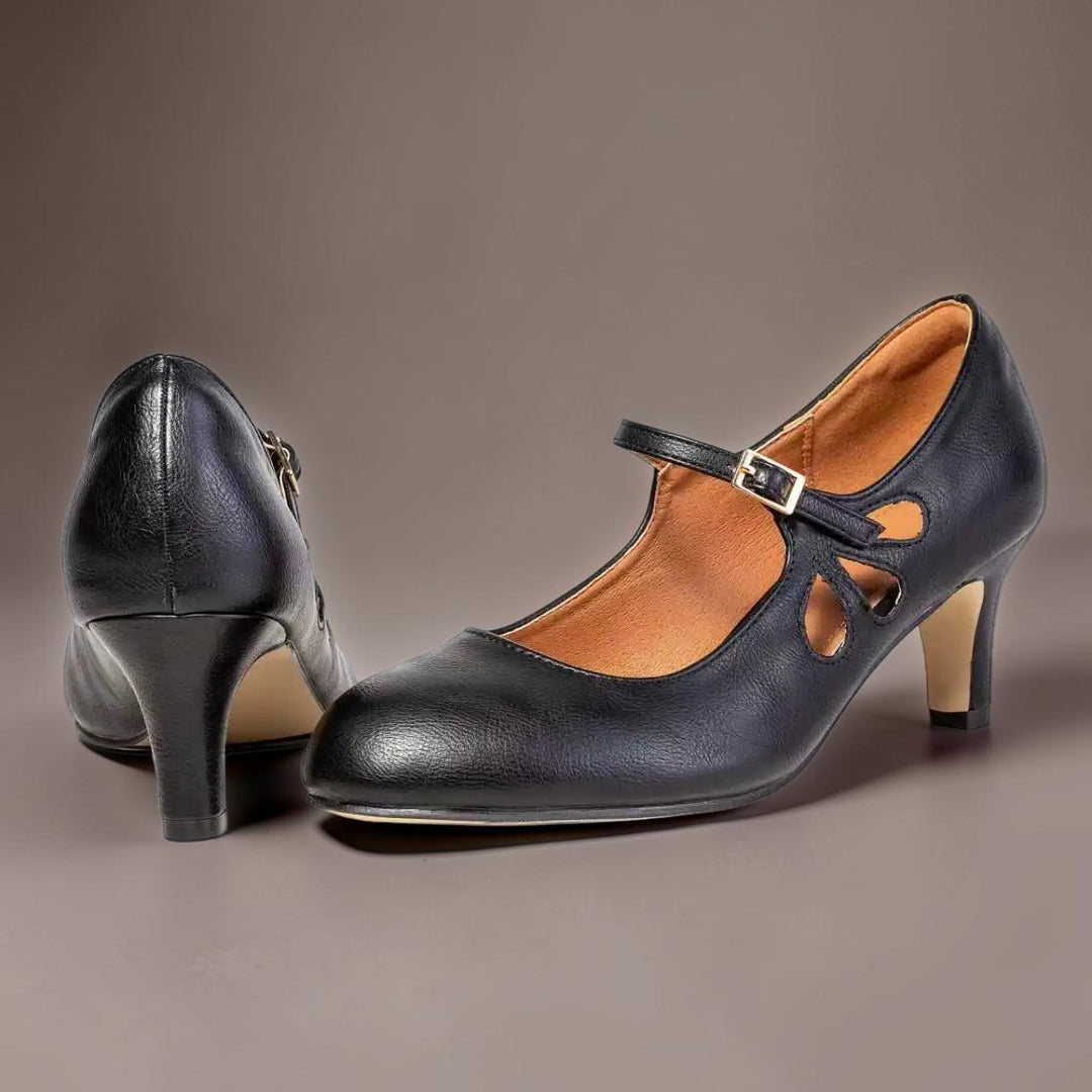 Vivian &amp; Cole Odette classic black office pumps with a manageable heel, closed-toe design, and buckled mary jane strap.