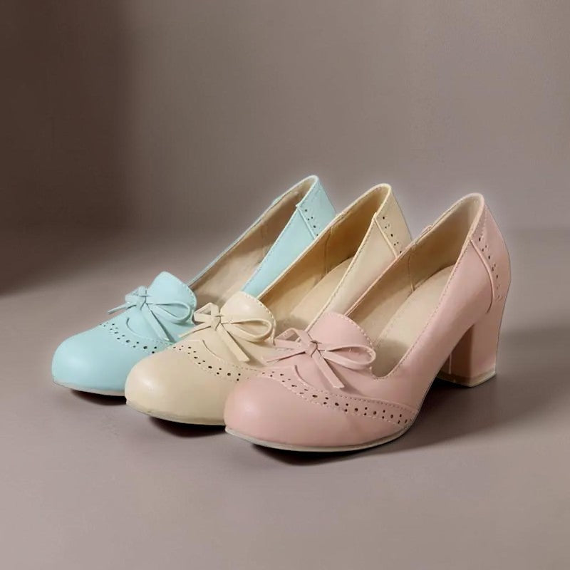 Vivian &amp; Cole Adelaide bow slip-on pumps in blue, beige, and pink with a block heel and decorative brogue detailing.