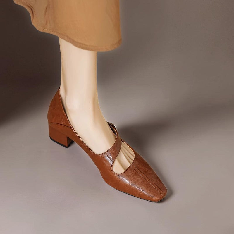 Vivian &amp; Cole brown leather Mary Jane pump with a chiseled square toe, cut-out vamp, and low block heel on a foot.