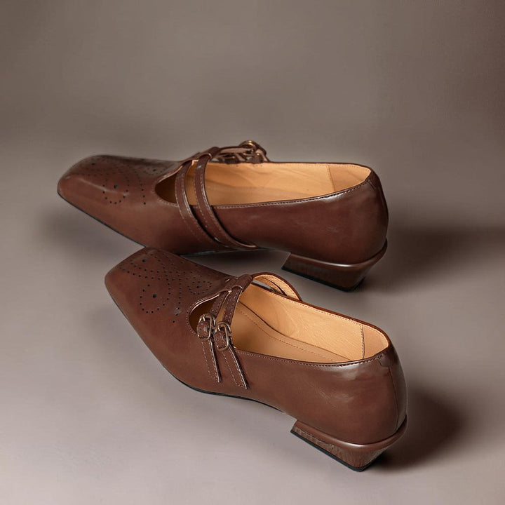 Vivian &amp; Cole Marisol brown leather Mary Jane pumps with brogue detailing, dual buckled straps, and low block heels.
