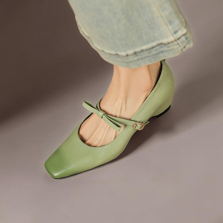 Vivian &amp; Cole Bryony green leather Mary Jane pump with a bow-strap and concealed block heel worn with denim jeans