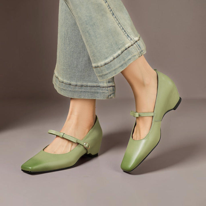 Vivian &amp; Cole green leather Mary Jane pumps with a bow-strap and concealed block heel worn with cropped denim jeans.