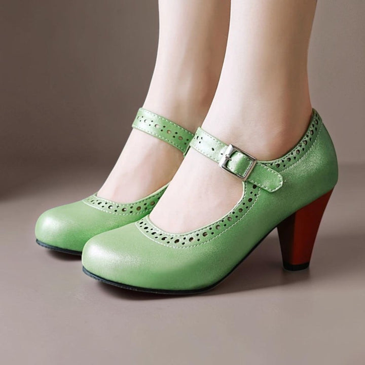 Vivian &amp; Cole Genevieve green Mary Jane heels with an adjustable strap, rounded toe, and contrasting wooden block heel