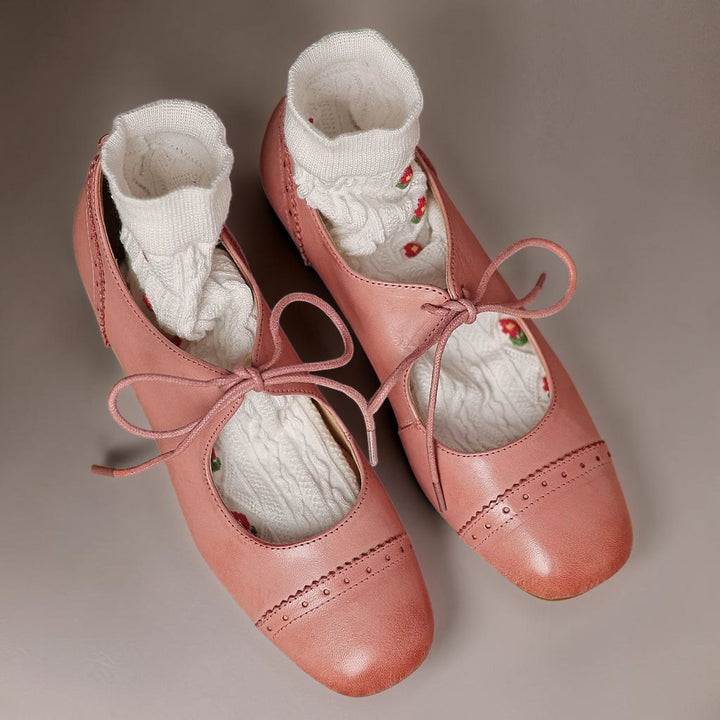 Vivian &amp; Cole Constance pink leather oxfords with carved detailing and a low block heel worn with white floral socks.