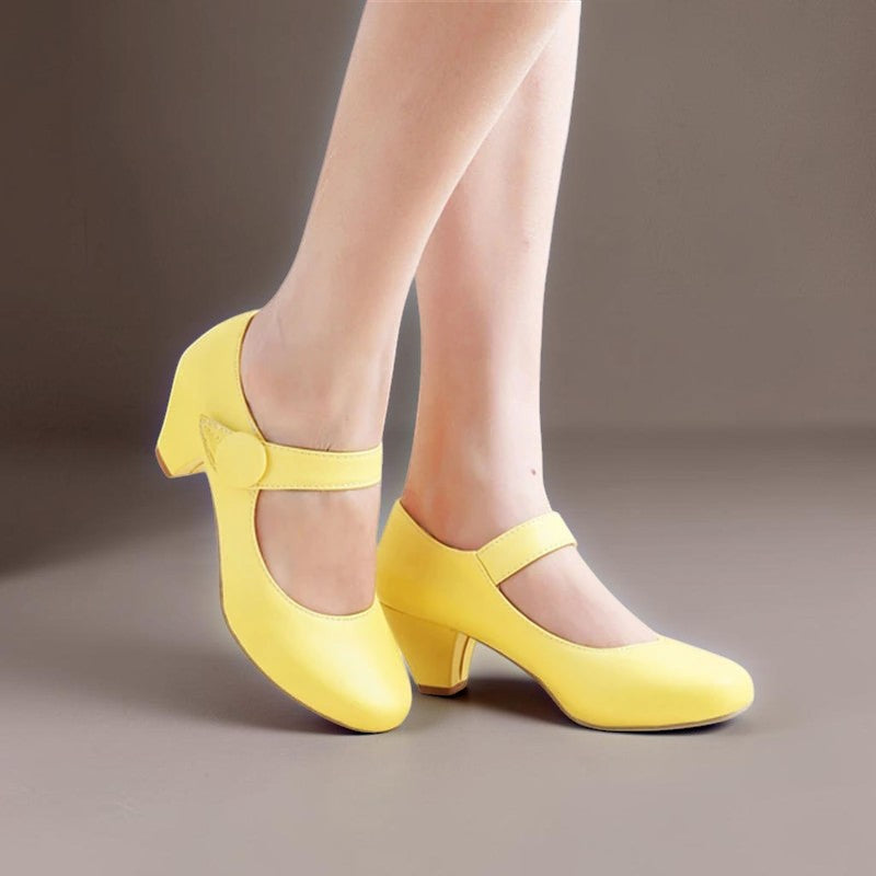 Vivian &amp; Cole Clementine yellow block heel Mary Jane shoes with an adjustable instep strap and rounded toe box.