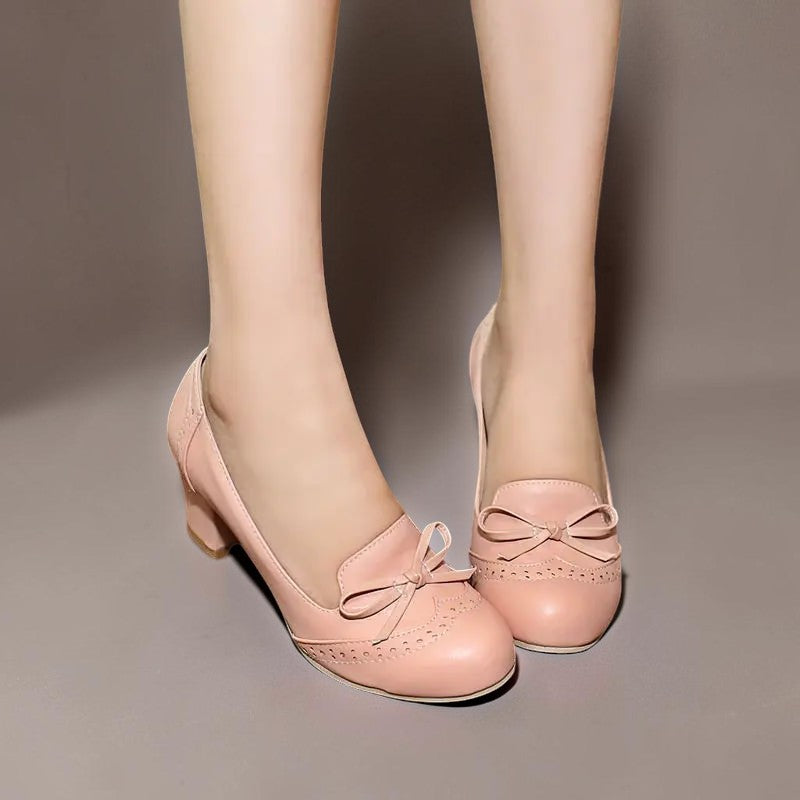 Vivian &amp; Cole Adelaide pink bow slip-on pumps with a manageable block heel and decorative brogue detailing