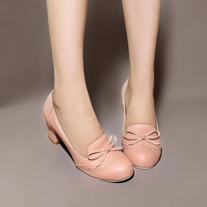 Vivian &amp; Cole Adelaide pink bow slip-on pumps with a manageable block heel and decorative brogue detailing