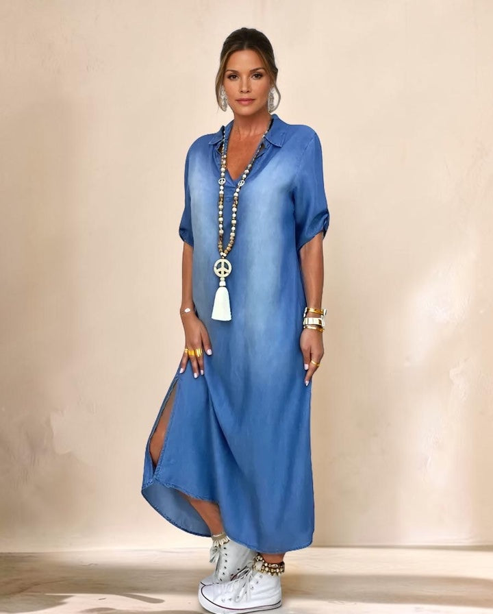 Vivian & Cole Anthyrah blue denim midi dress with rolled sleeves, side split, and loose fit worn by a model