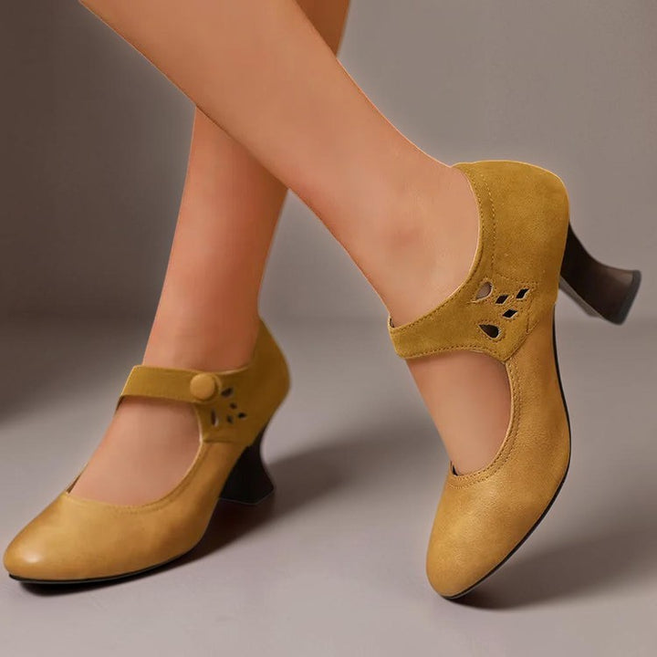 Vivian &amp; Cole Antonia yellow suede round-toe heels with a stable block heel and secure ankle strap on a model