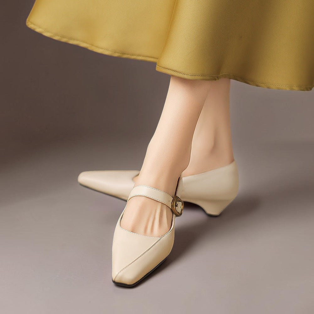 Vivian &amp; Cole beige leather Mary Jane heels with paneled stitching, gold-tone buckle, and low block heel on a model
