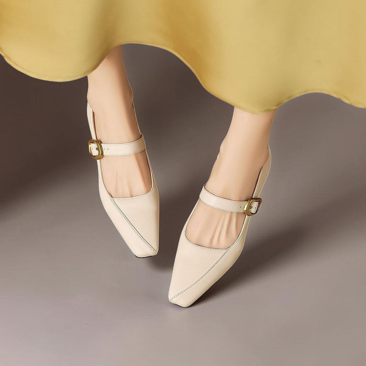 Vivian &amp; Cole beige leather paneled Mary Jane heels with a gold-tone buckle and low block heel on a model