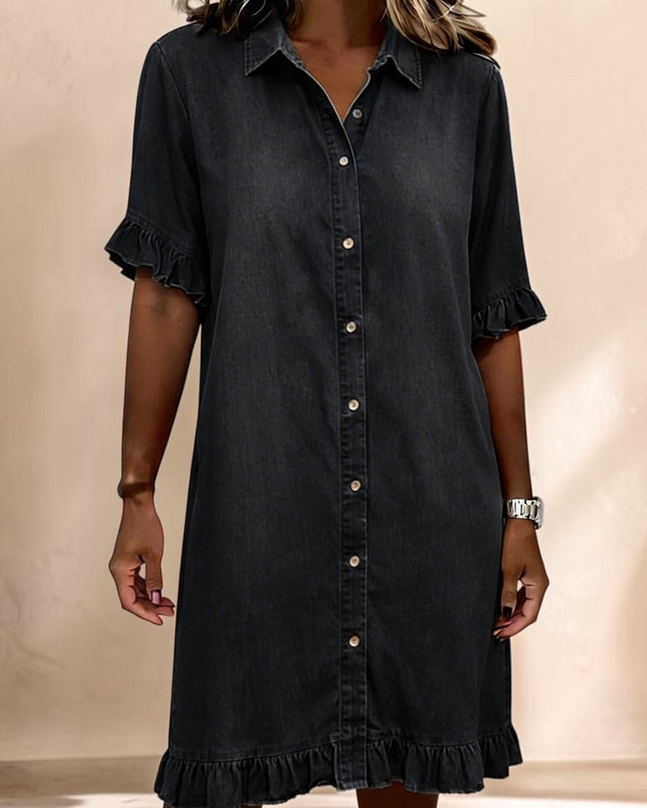 Vivian &amp; Cole black denim smocked waist dress with a button-down front, collar, and ruffled sleeve and hem details.