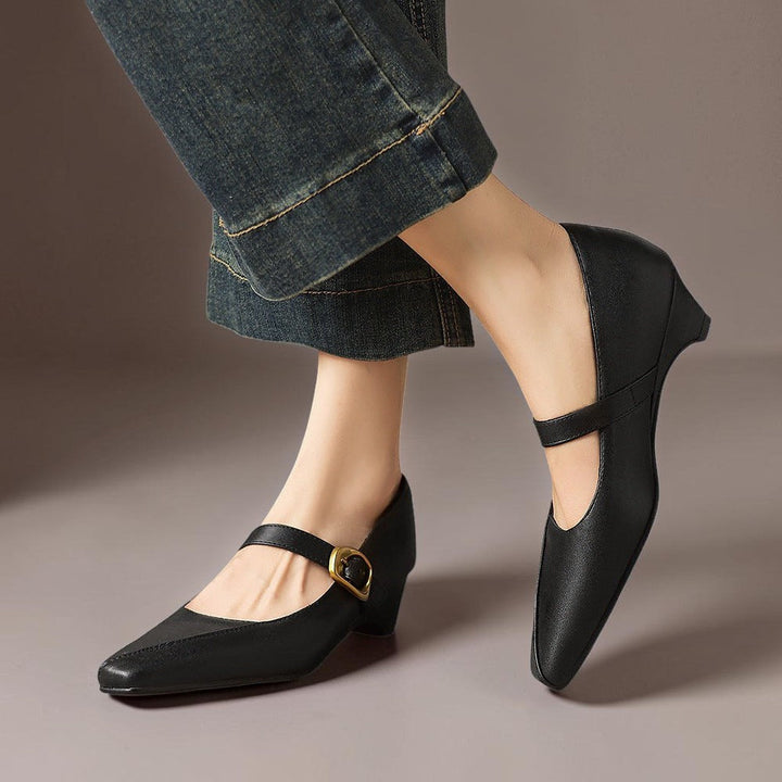 Vivian &amp; Cole black leather paneled Mary Jane heels with a gold-tone buckle and low block heel worn with jeans