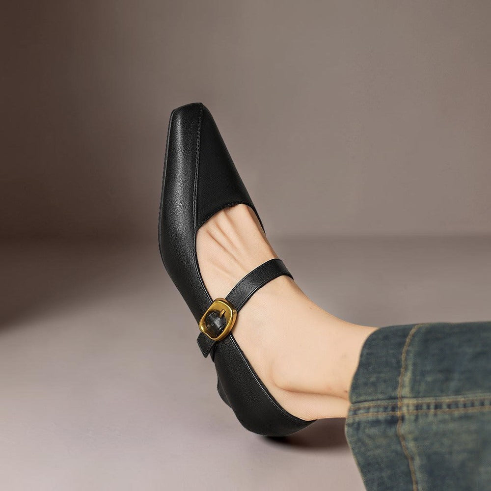 Vivian &amp; Cole black leather Mary Jane heels with paneled construction, square toe, and a statement gold-tone buckle.