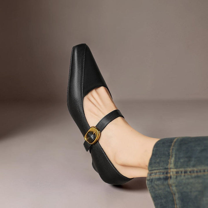 Vivian &amp; Cole black leather Mary Jane heels with paneled construction, square toe, and a statement gold-tone buckle.