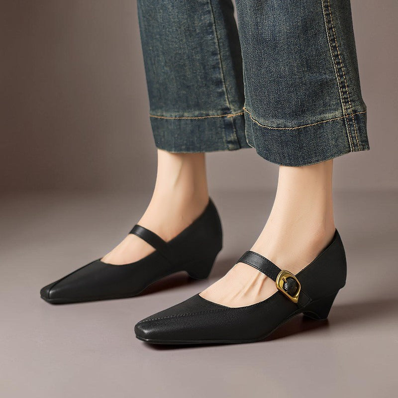 Vivian &amp; Cole black leather Mary Jane heels with paneled stitching, a low block heel, and a statement gold buckle.