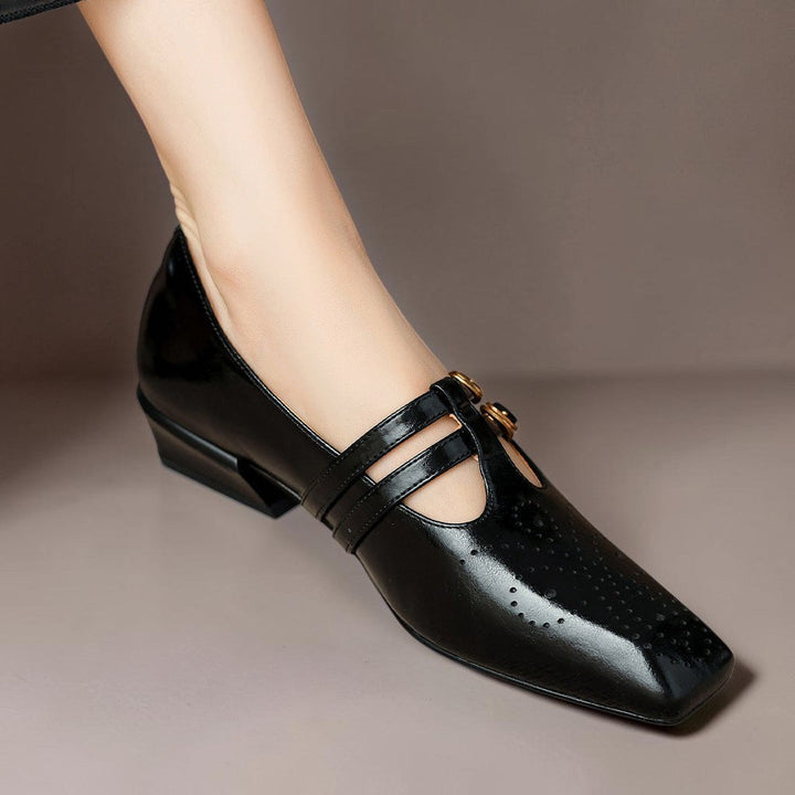 Vivian &amp; Cole black leather Mary Jane pump with brogue detailing, dual buckled straps, and a low block heel.