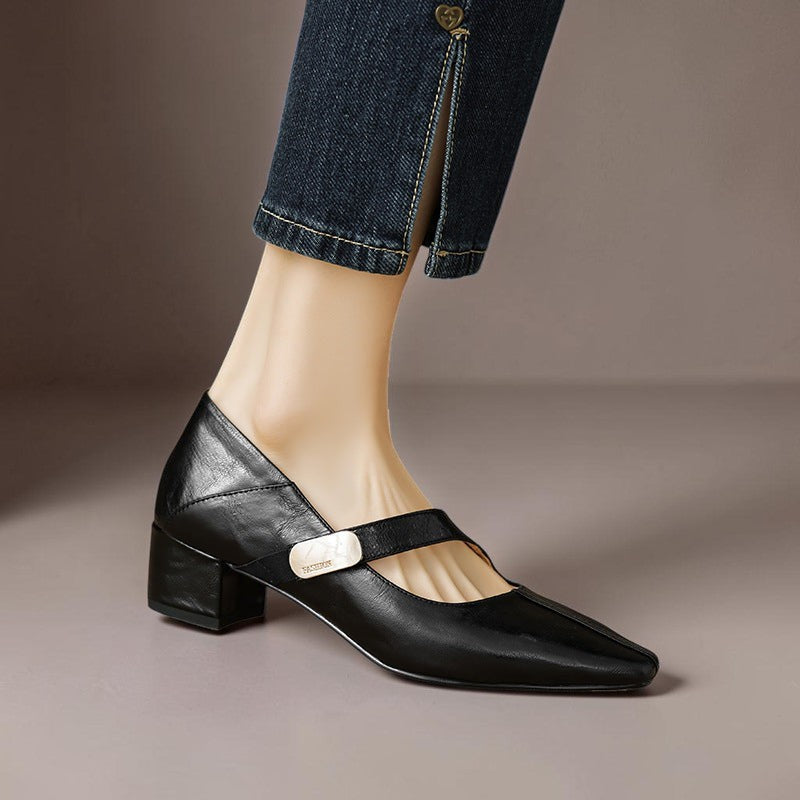 Vivian &amp; Cole black leather Mary Jane pump featuring a chiseled square toe, gold bit accent, and low block heel.