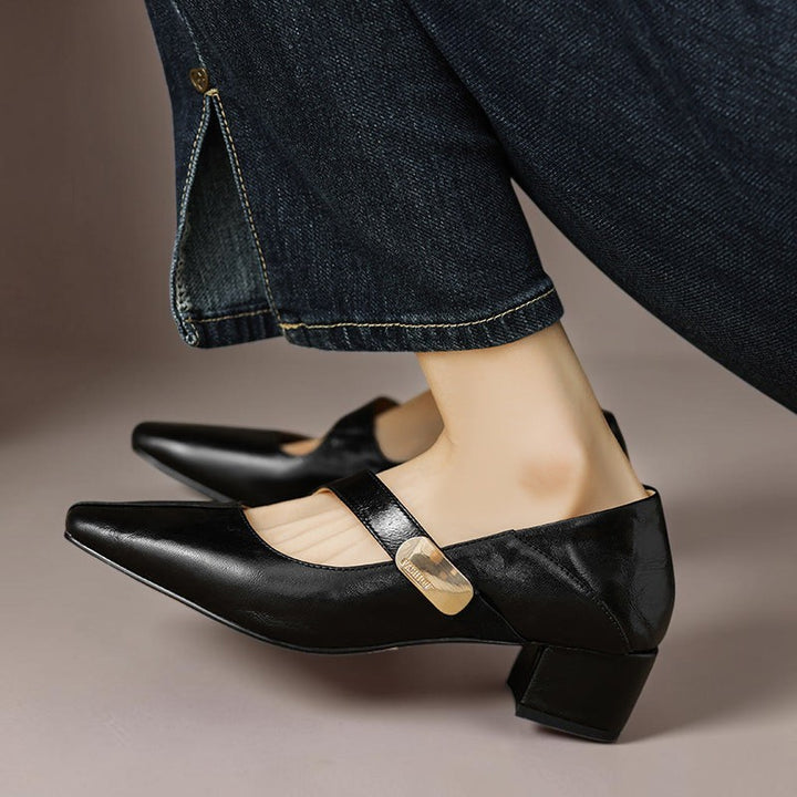 Vivian &amp; Cole black leather Mary Jane pumps with a chiseled square toe, gold bit accent, and low block heel.