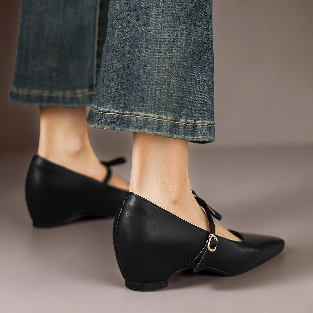 Vivian &amp; Cole black leather Mary Jane pumps featuring a bow-strap and a concealed block heel worn with denim jeans.