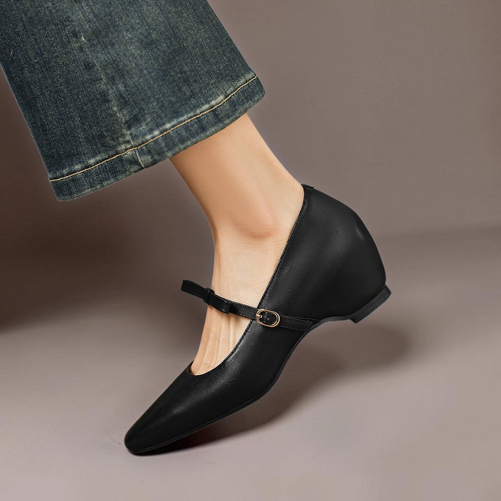 Vivian &amp; Cole black leather Mary Jane pump with a bow-strap and concealed block heel worn with denim jeans