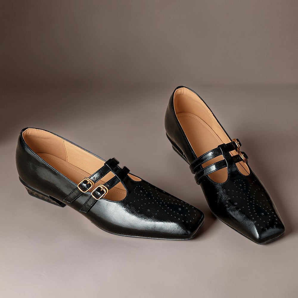 Vivian &amp; Cole Marisol black leather Mary Jane pumps with brogue detailing, dual buckled straps, and a low block heel.