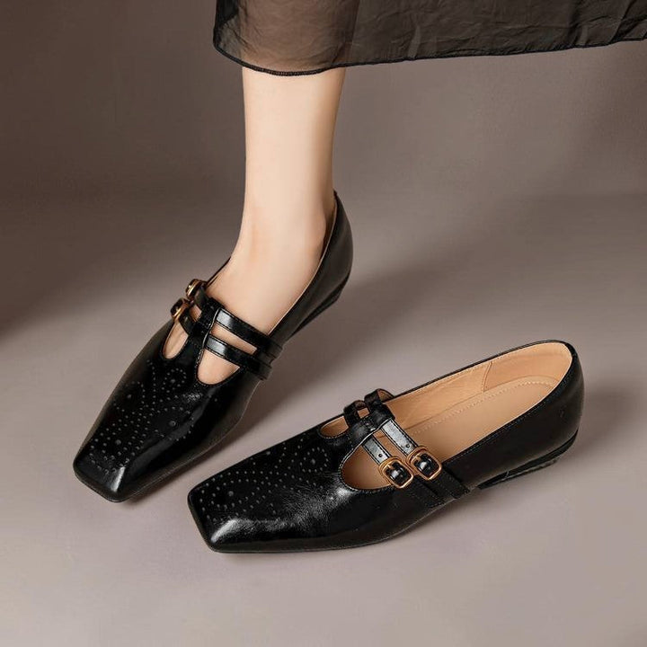 Vivian &amp; Cole Marisol black leather Mary Jane pumps featuring brogue perforation and dual adjustable buckled straps.