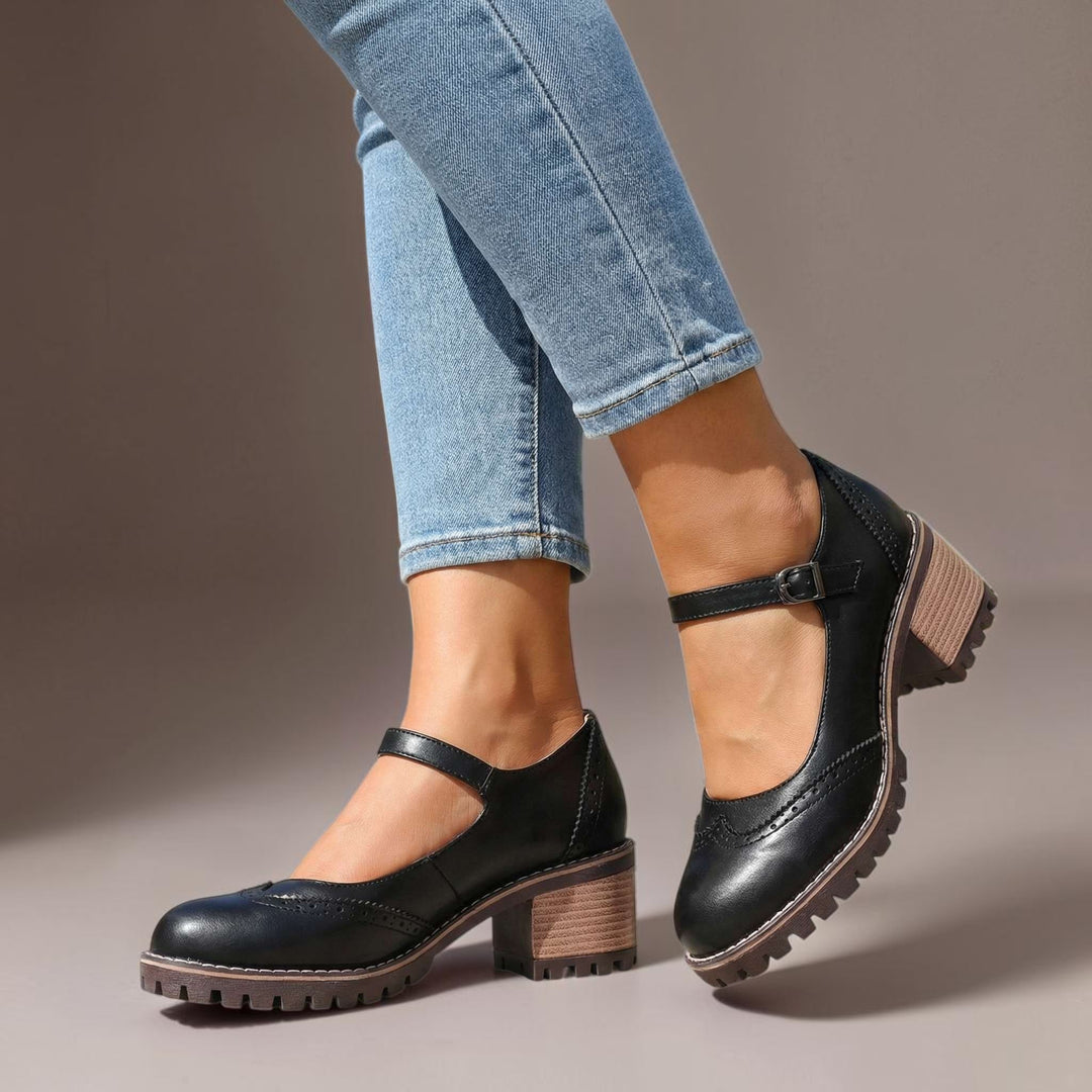 Vivian &amp; Cole black leather Marie T-strap Mary Jane heels with a chunky block heel and buckle closure on a model