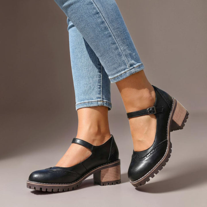 Vivian &amp; Cole black leather Marie T-strap Mary Jane heels with a chunky block heel and buckle closure on a model