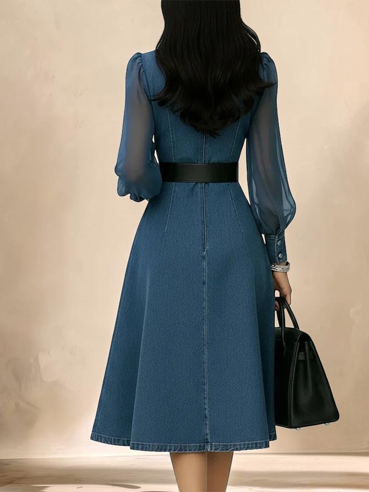 Back view of a Vivian &amp; Cole blue denim maxi dress with sheer puff sleeves and a black waist belt