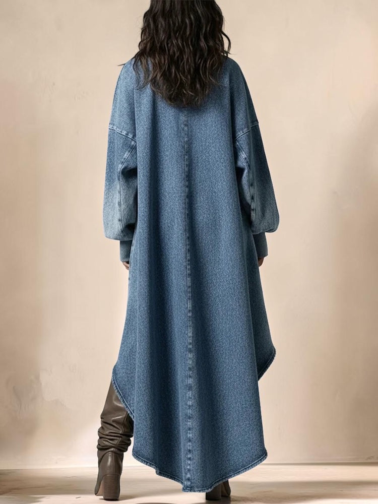 Back view of a woman wearing a Vivian & Cole blue denim maxi dress with lantern sleeves and a high-low hem.