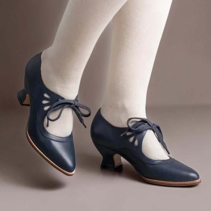 Vivian &amp; Cole blue vintage-style Mary Jane pumps with lace-up detail, rounded toe, and comfortable low block heel.