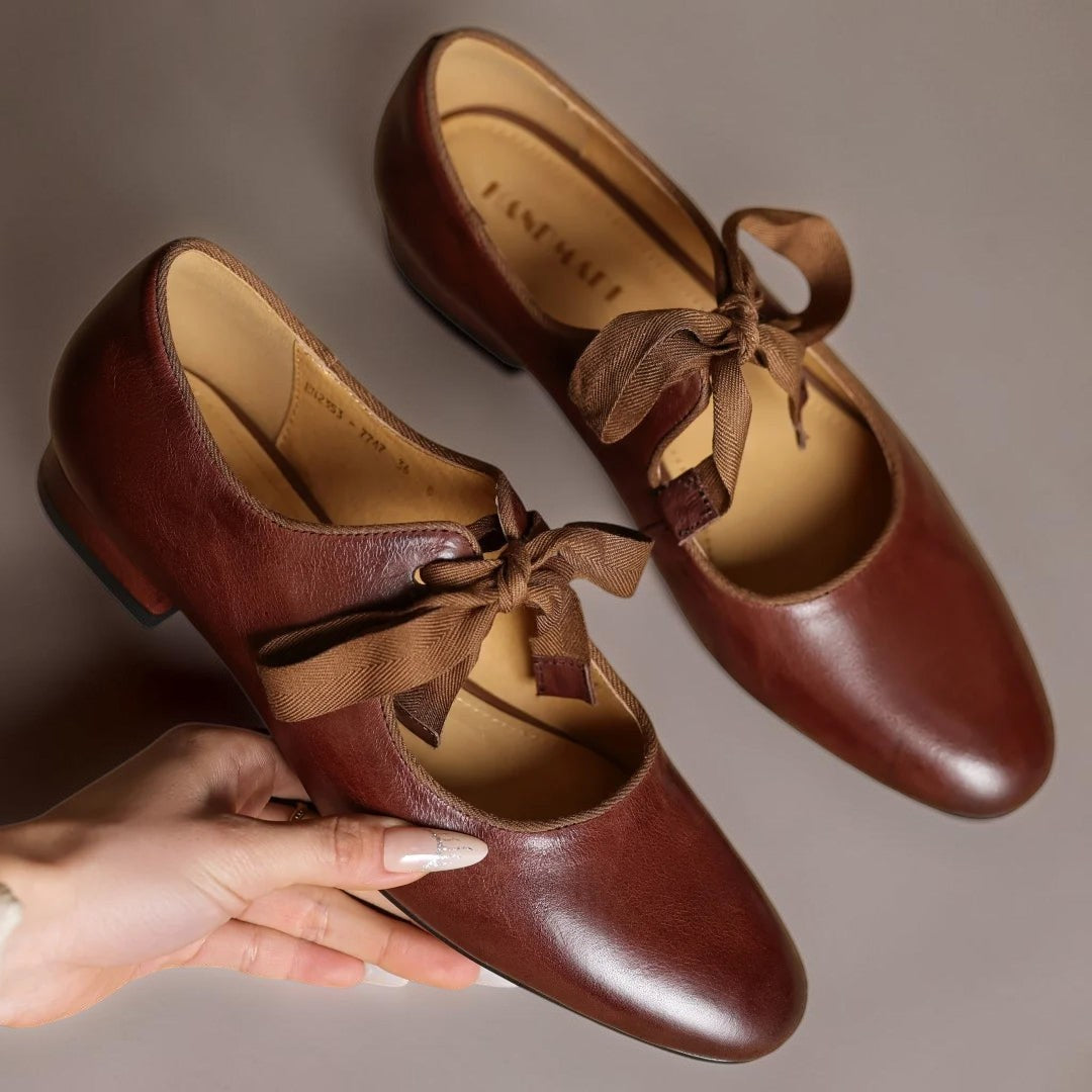 Vivian &amp; Cole Rosamund brown leather Mary Jane flats featuring a delicate ribbon bow and a flexible flat sole.