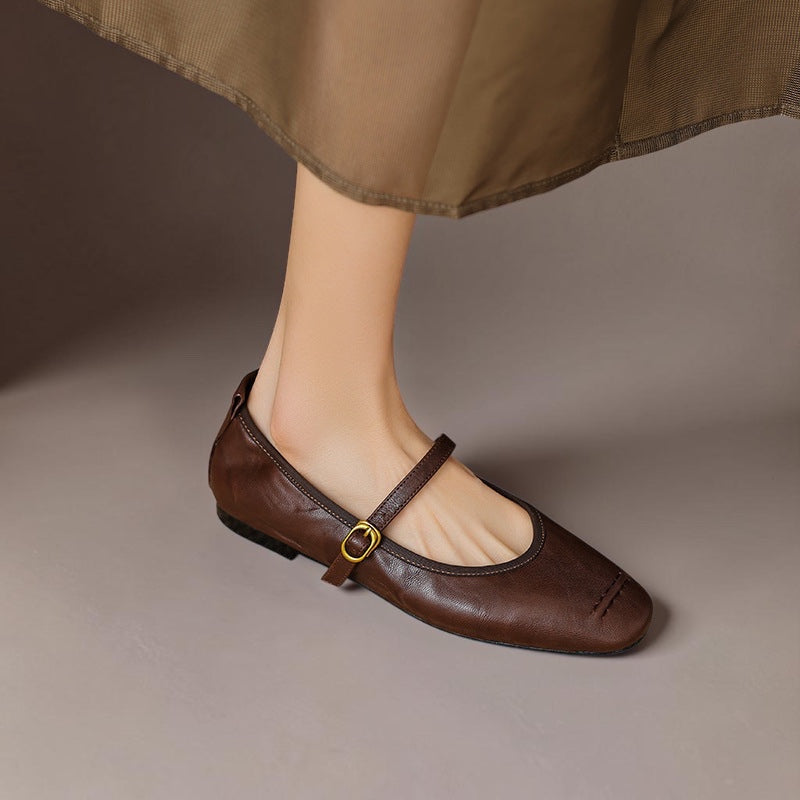 Vivian & Cole Wani brown leather Mary Jane flats with a buckled strap and cushioned insole worn with a midi skirt