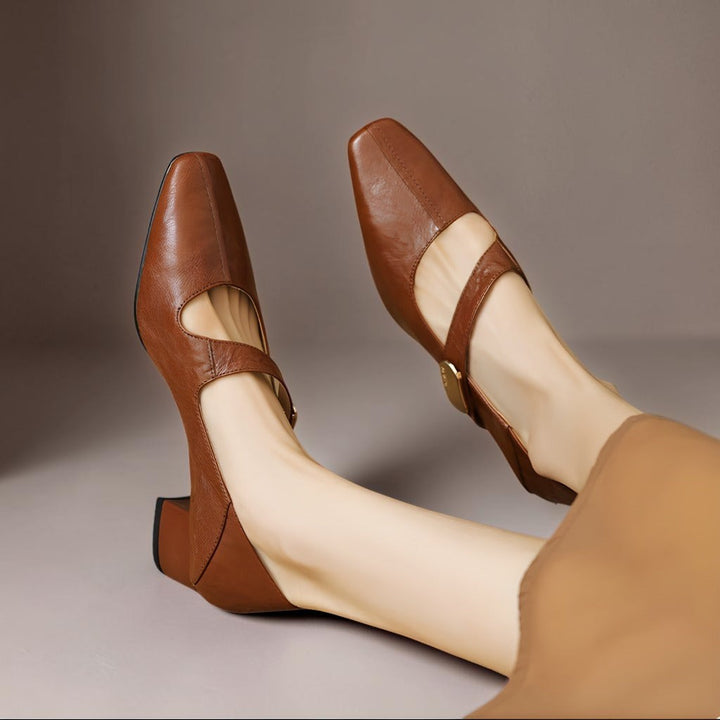 Vivian &amp; Cole brown leather Mary Jane pumps with a chiseled square toe, gold bit detail, and low block heel.
