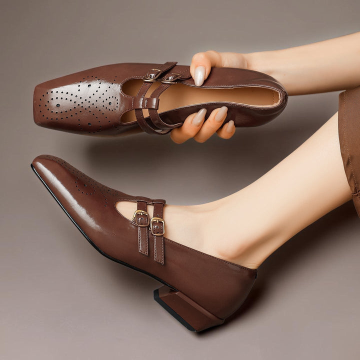 Vivian &amp; Cole Marisol brown leather Mary Jane pumps with brogue perforations, dual buckled straps, and a low block heel.