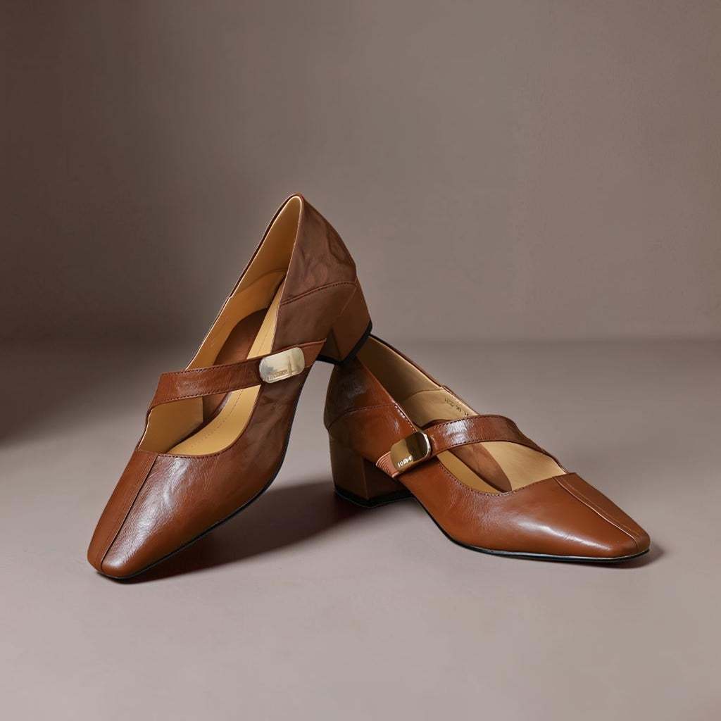 Vivian &amp; Cole brown leather Mary Jane pumps with a chiseled square toe, gold bit hardware, and a low block heel.