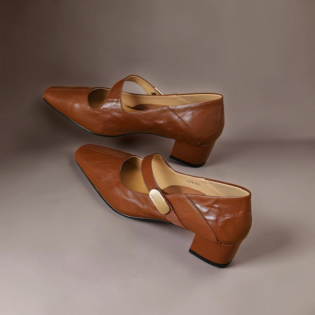 Vivian &amp; Cole brown leather Mary Jane pumps with a chiseled square toe, gold bit accent, and low block heel.