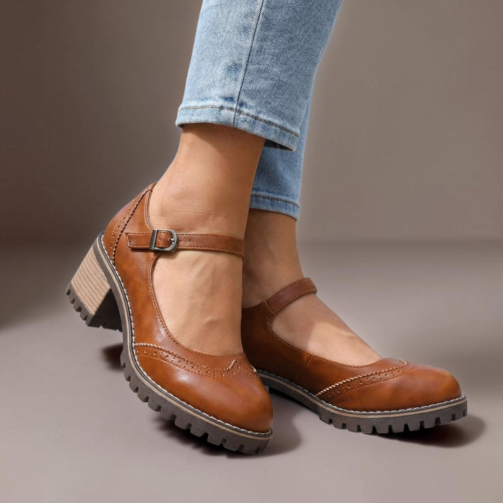 Vivian &amp; Cole Marie brown leather T-strap Mary Jane heels with a chunky lug sole and buckle closure on a model