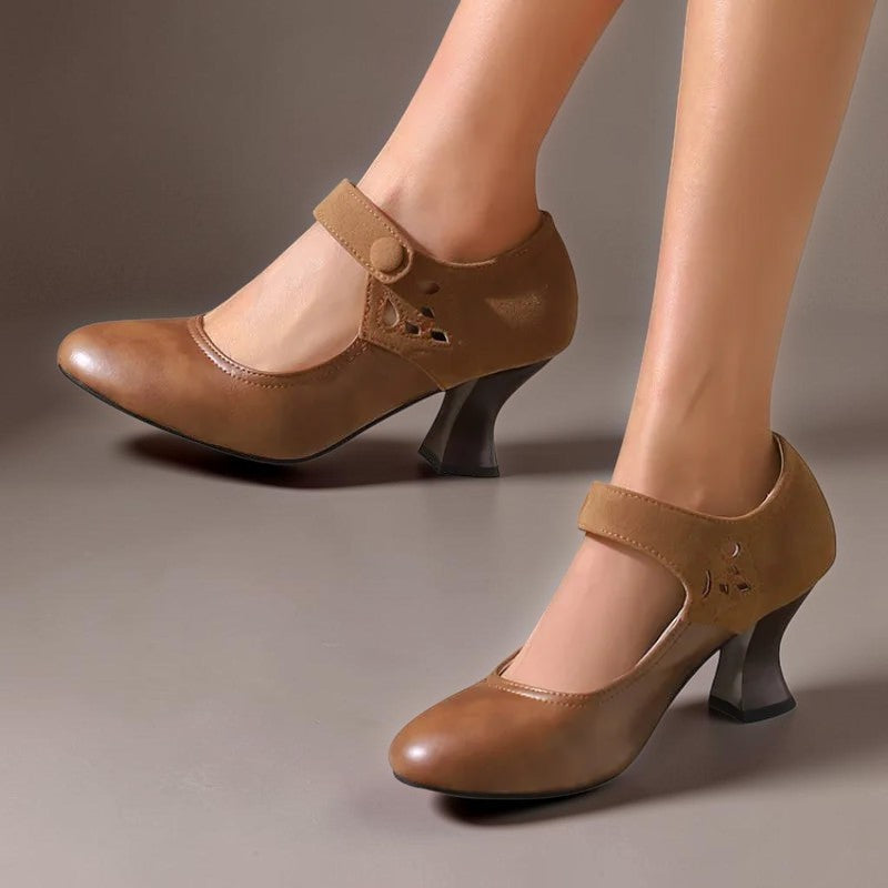 Vivian &amp; Cole brown suede round-toe heels with a stable flared heel and secure ankle strap worn on a model