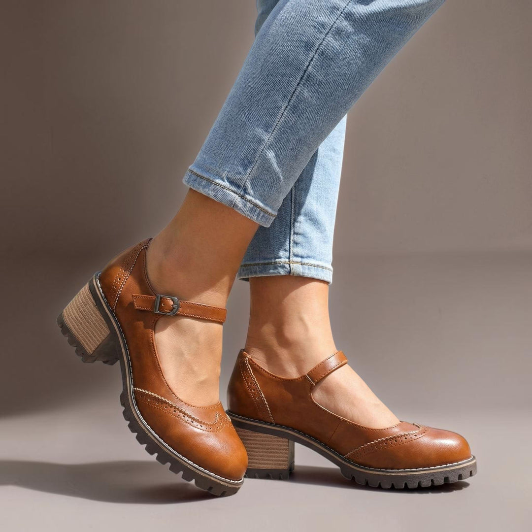 Vivian &amp; Cole brown T-strap Mary Jane heels with a chunky lug sole and buckle closure worn with light wash jeans