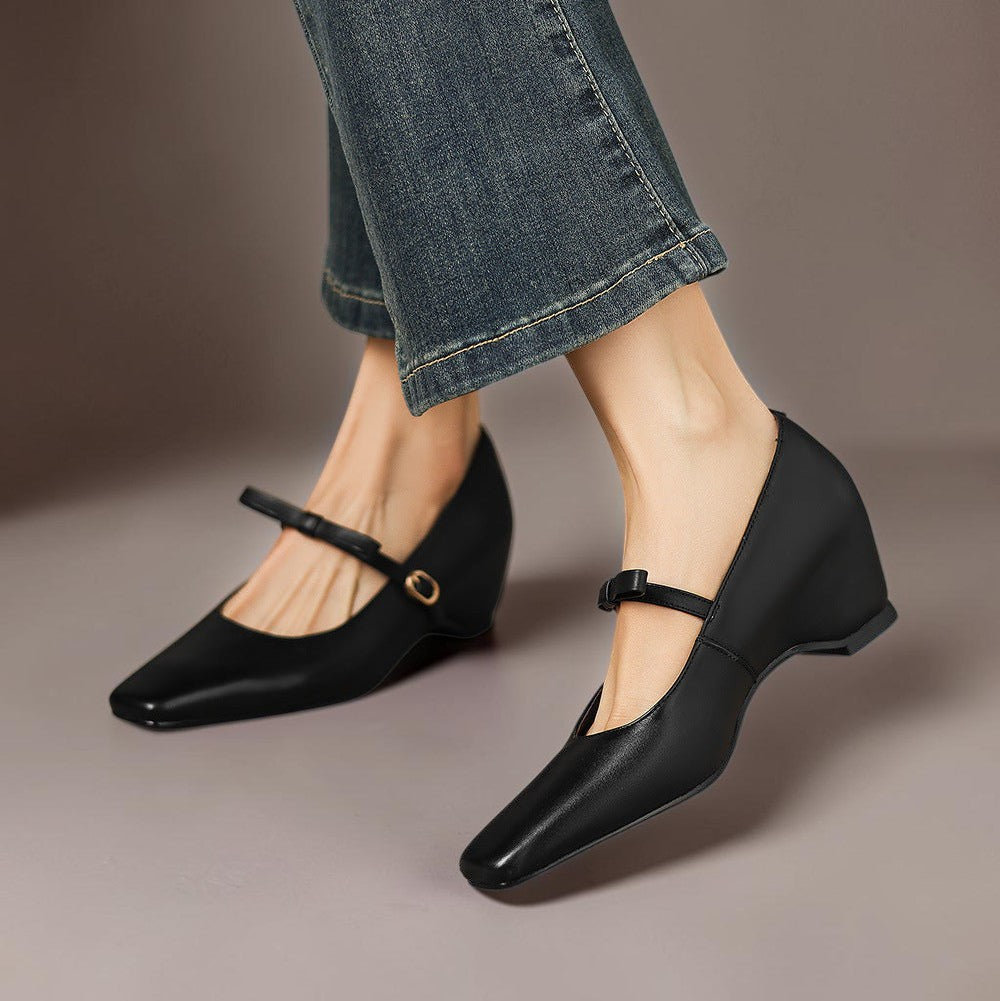 Vivian &amp; Cole Bryony black leather Mary Jane pumps with a bow-strap and concealed block heel worn with blue jeans.