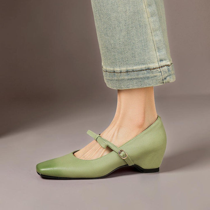 Vivian &amp; Cole Bryony green leather Mary Jane pump with a bow-tie strap and a concealed block heel on a model