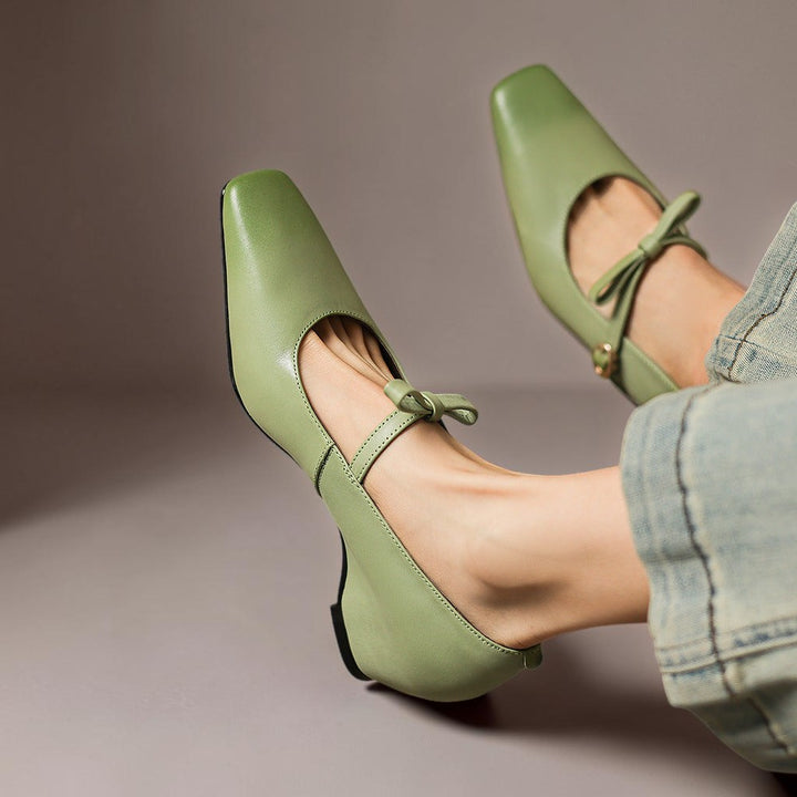 Vivian &amp; Cole Bryony green leather Mary Jane pumps with a bow-strap and concealed block heel worn with jeans