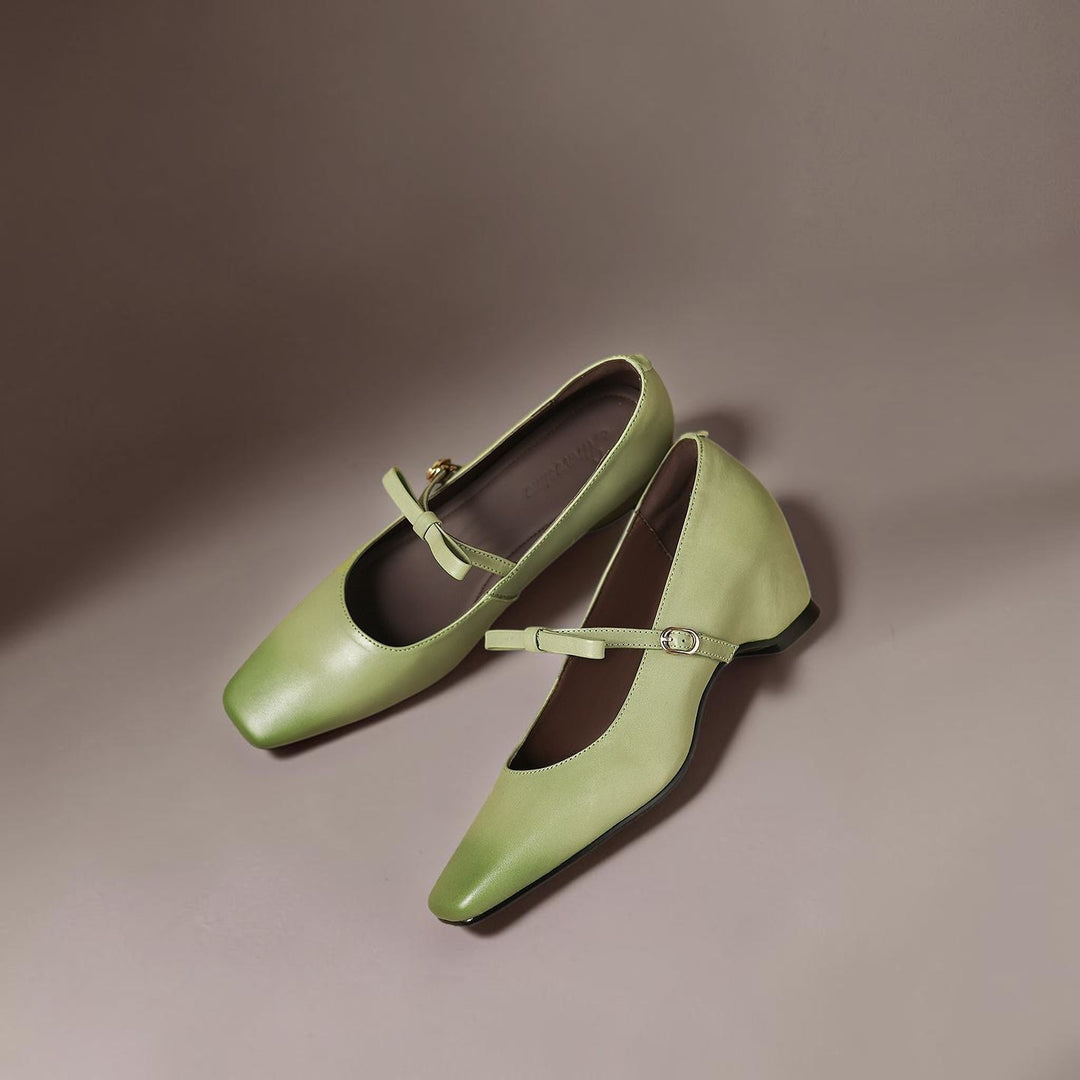 Vivian &amp; Cole Bryony green leather Mary Jane pumps with a bow-strap and concealed block heel on a neutral background
